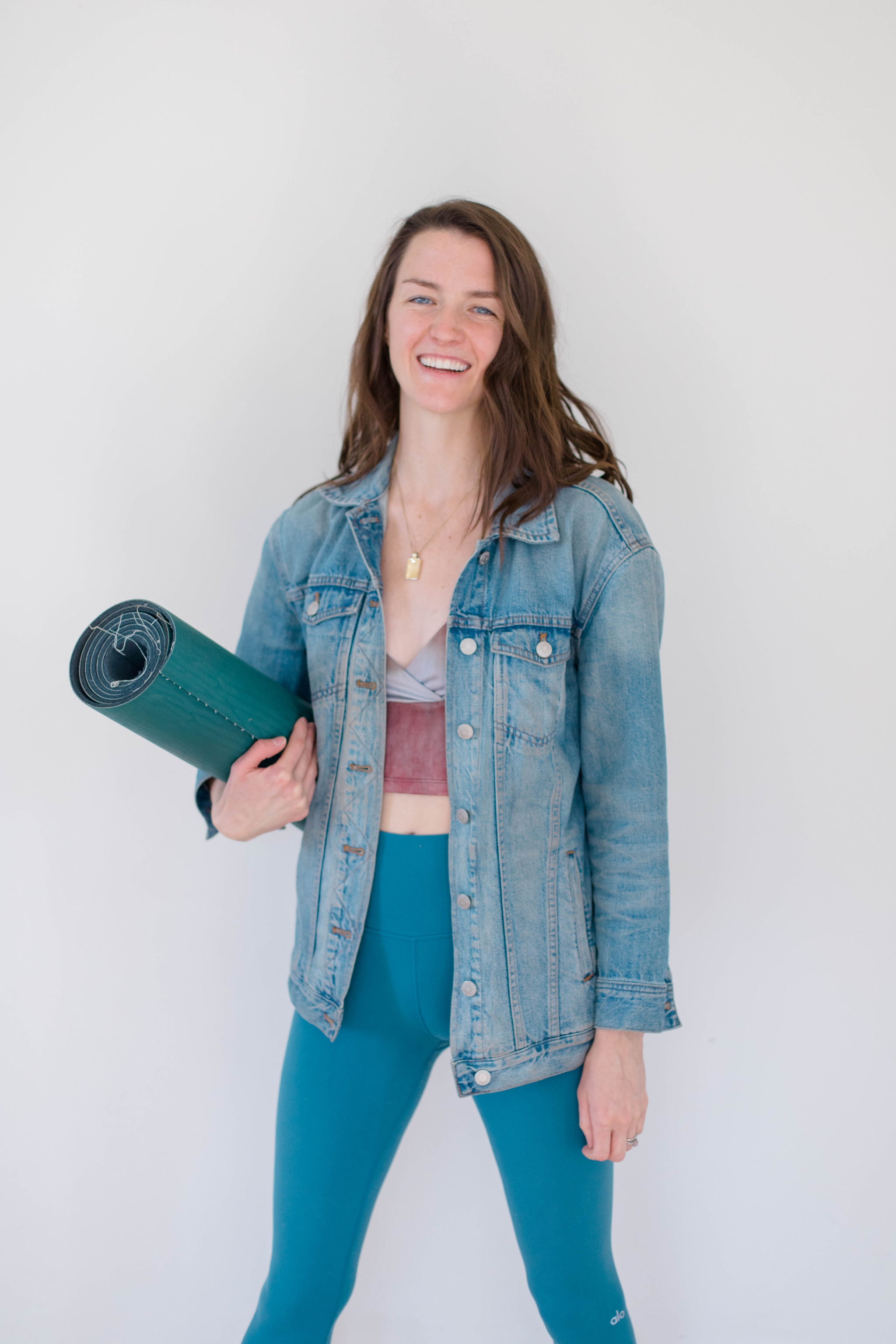 Nourish details Sheila holding her yoga mat