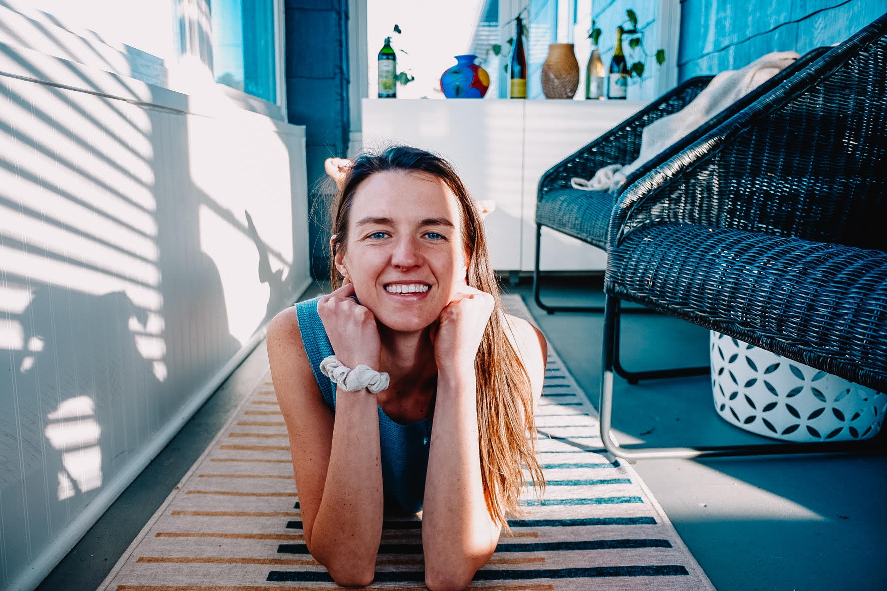 Sheila Anne on a brightly lit porch with a colorful rug